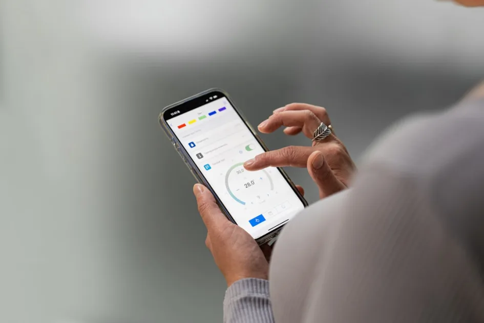 Hands holding a smartphone displaying a mobile application.
